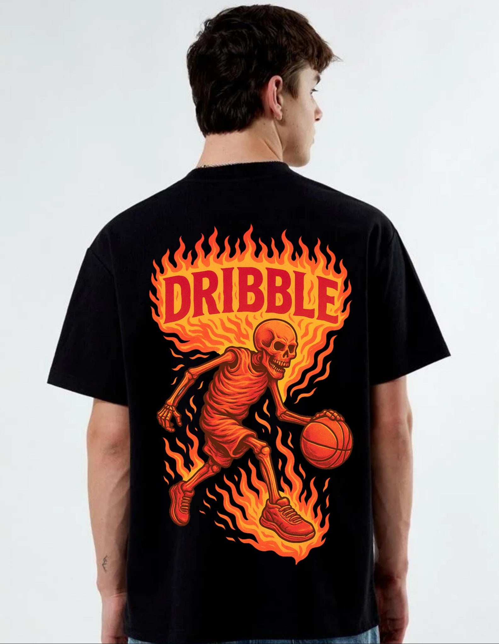 Person wearing a black t-shirt with a fiery skeleton dribbling a basketball design and 'Dribble' text.